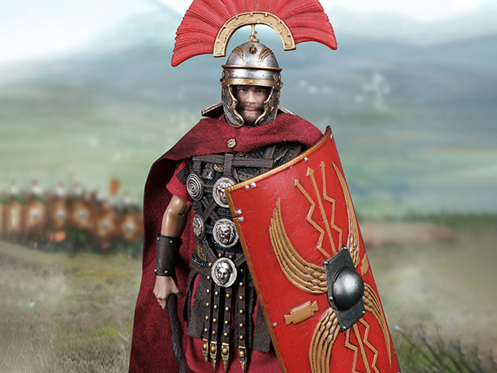 Armored man with a red feathered helmet, red cape, several silver medals, and red shield. On the shield are four yellow wings, two straight arrows, and four zigzagging arrows emanating from the center