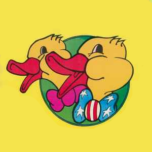 Two cartoon duck heads with bow ties, one pink, the other decorated as the American flag; on a green circle against a yellow background