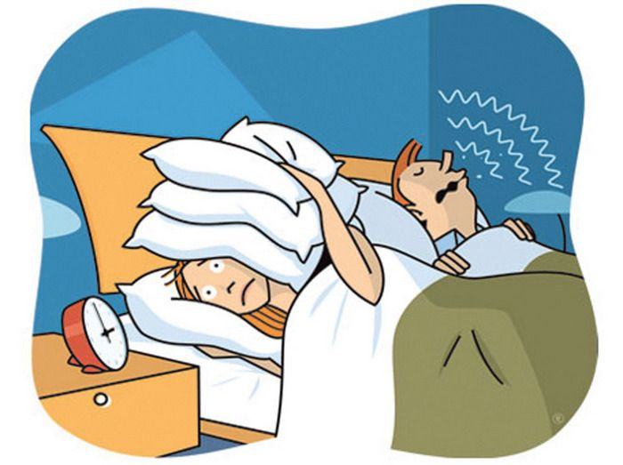 Two people laying in bed, the left one has their eyes open and is covering their ears with a stack of pillows, while the right person's eyes are closed and zigzags are drawn around their mouth